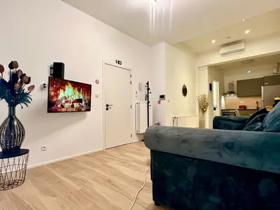 a living room with a couch and a kitchen at Luxury Suites Royal by Rikas Hotels in Antwerp