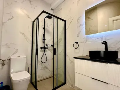 a bathroom with a shower and a toilet at Luxury Suites Royal by Rikas Hotels in Antwerp