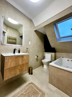 a bathroom with a sink and a tub and a toilet at Luxury Suites Royal by Rikas Hotels in Antwerp