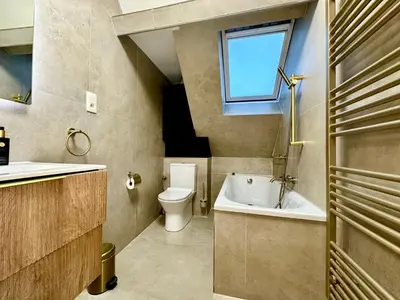a bathroom with a toilet and a sink and a tub at Luxury Suites Royal by Rikas Hotels in Antwerp