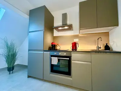 a kitchen with an oven and a sink at Luxury Suites Royal by Rikas Hotels in Antwerp