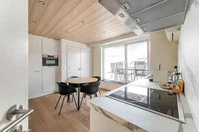 a kitchen and dining room with a table and chairs at Luxury apartment x big terrace in Sint-Niklaas