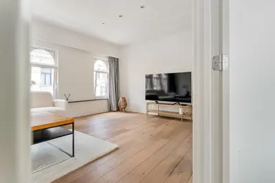 a living room with a couch and a tv at Luxury apartment x big terrace in Sint-Niklaas
