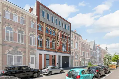 a row of buildings on a street with parked cars at Luxury apartment x big terrace in Sint-Niklaas