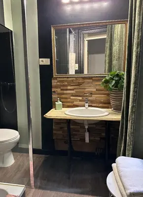 a bathroom with a sink and a mirror at Happy Home in Brussels