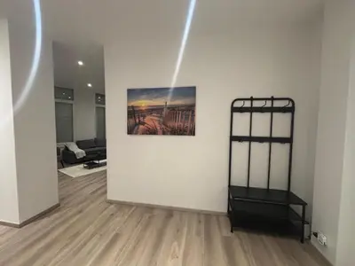 a living room with a painting on the wall at Appartement Leyla in Brussels