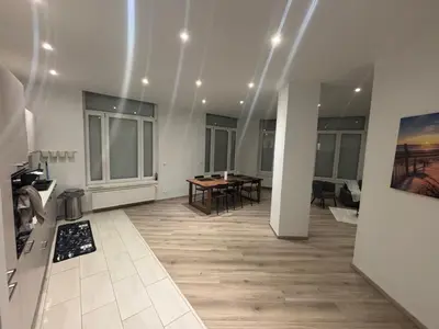 a room with a table and chairs in a building at Appartement Leyla in Brussels