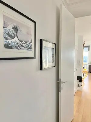 a hallway with two framed pictures on the wall at Lovely loft in Panoramic View! in Brussels