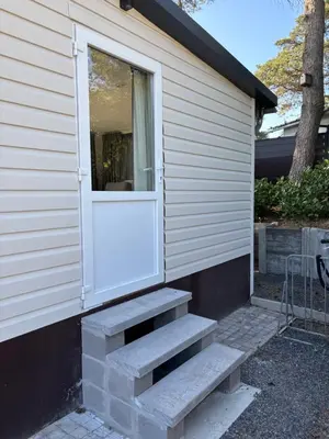 a door on the side of a house with stairs at Nomad Laryssiou on camping GT Keiheuvel parcel 371 in Balen