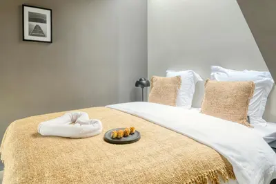 a bed with a tray of food on top of it at Serene Studio Oasis with Balcony in Ghent in Ghent