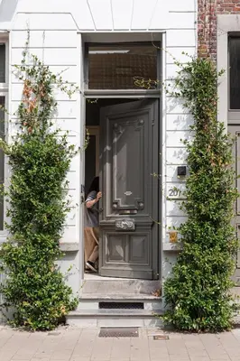 a man standing in the door of a house at Serene Studio Oasis with Balcony in Ghent in Ghent