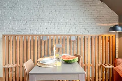 a table with a bowl of watermelon on it at Serene Studio Oasis with Balcony in Ghent in Ghent
