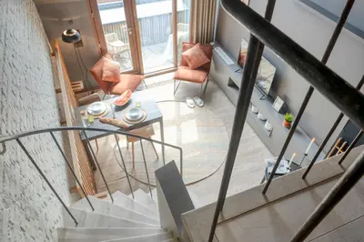 an overhead view of a staircase with a table and chairs at Serene Studio Oasis with Balcony in Ghent in Ghent