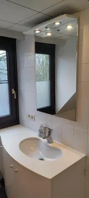 a bathroom with a sink and a mirror at Cosy apartment in Brasschaat near Antwerp in Brasschaat