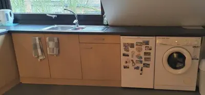 a kitchen with a sink and a washing machine at Cosy apartment in Brasschaat near Antwerp in Brasschaat