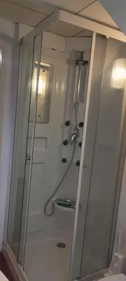 a bathroom with a shower with a glass door at Cosy apartment in Brasschaat near Antwerp in Brasschaat