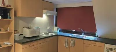 a small kitchen with a sink and a microwave at Cosy apartment in Brasschaat near Antwerp in Brasschaat