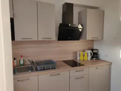 a kitchen with a sink and a counter top at Lisbethe in Brussels