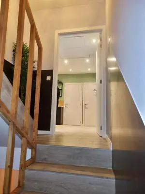 a stairway leading to a room with a door at Plantin 4 in Brussels