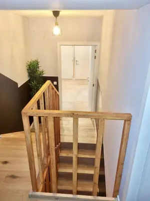 a staircase leading up to a room with a door at Plantin 4 in Brussels