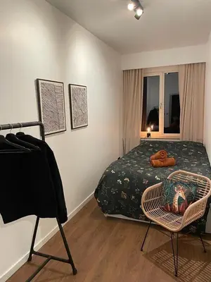 a bedroom with a bed and a chair in it at The Green Gatsby in Antwerp