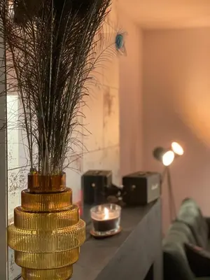 a gold vase with a plant on a table at The Green Gatsby in Antwerp