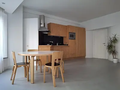a kitchen and dining room with a table and chairs at Spacious next to Grand Place in Brussels