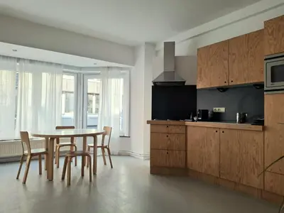 a kitchen with a table and chairs in a room at Spacious next to Grand Place in Brussels