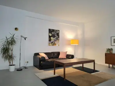 a living room with a couch and a coffee table at Spacious next to Grand Place in Brussels