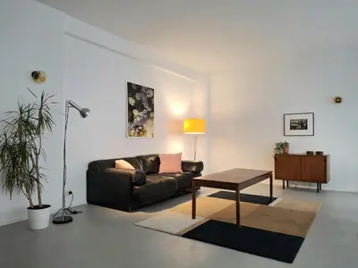 a living room with a couch and a table at Spacious next to Grand Place in Brussels