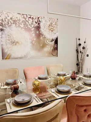 a dining room with a glass table and chairs at l'imperial WIFI & Confort in Brussels