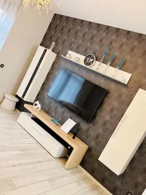 a living room with a flat screen tv on a wall at l'imperial WIFI & Confort in Brussels
