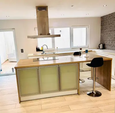 a kitchen with a counter with a sink and a desk at l'imperial WIFI & Confort in Brussels