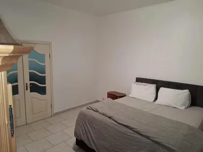 a bedroom with a bed and an open door at House near Forest 125 m² for 6 guests in Brussels