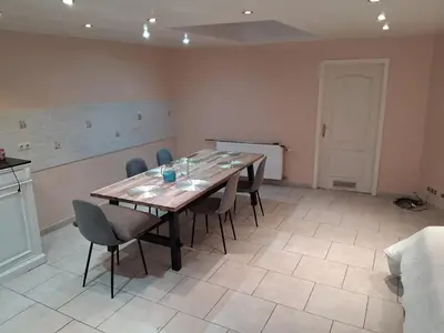 a dining room with a wooden table and chairs at House near Forest 125 m² for 6 guests in Brussels