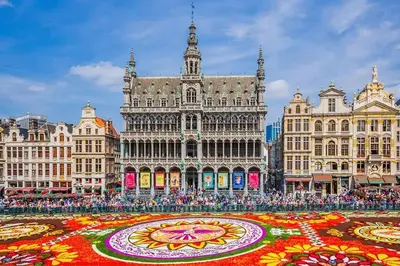 a crowd of people standing in front of a large building with a large flower carpet at House near Forest 125 m² for 6 guests in Brussels