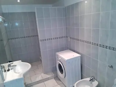 a bathroom with a toilet and a sink and a washing machine at House near Forest 125 m² for 6 guests in Brussels