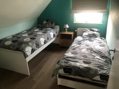 a bedroom with two beds and a window at Julie's Place in Westerlo