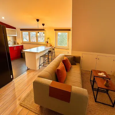 a living room with a couch and a kitchen at Brussels Quiet Oasis in Brussels