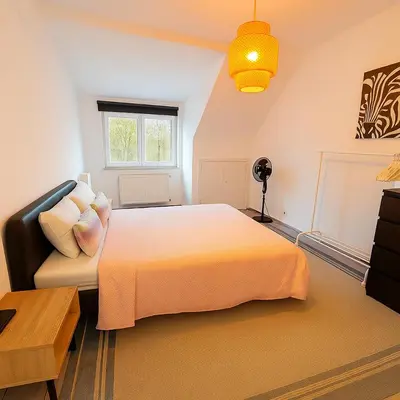 a bedroom with a large bed and a couch at Brussels Quiet Oasis in Brussels
