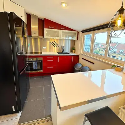 a kitchen with red cabinets and a counter top at Brussels Quiet Oasis in Brussels