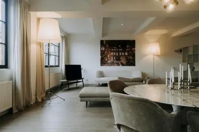 a living room with a table and a couch at Magnificent loft - 3 bedroom duplex in Brussels