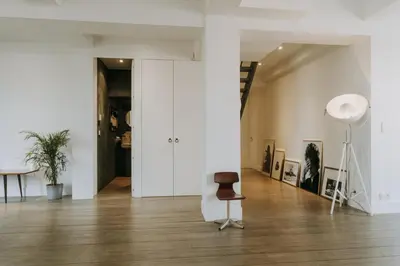 a white room with a chair and a table at Magnificent loft - 3 bedroom duplex in Brussels