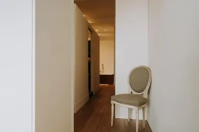 a chair sitting in a room with a hallway at Magnificent loft - 3 bedroom duplex in Brussels