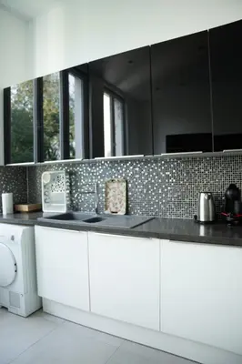 a kitchen with white cabinets and black counter tops at Cozy and luxurious apartment in Brussels, Laeken in Brussels