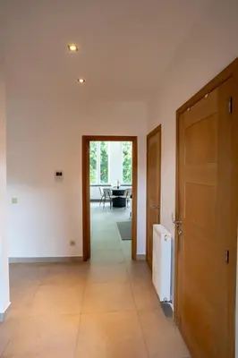 a hallway with a door leading to a dining room at Cozy and luxurious apartment in Brussels, Laeken in Brussels
