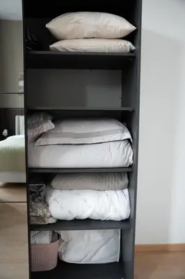 a shelf filled with white pillows in a room at Cozy and luxurious apartment in Brussels, Laeken in Brussels