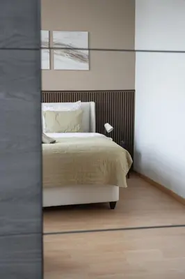 a bedroom with a bed and a mirror at Cozy and luxurious apartment in Brussels, Laeken in Brussels