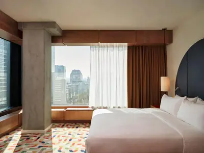 a bedroom with a large bed and a large window at The Standard, Brussels in Brussels