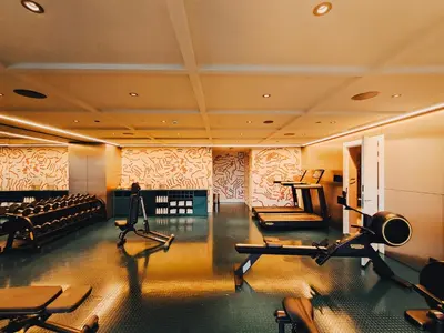 a gym with several treadmills and machines in a room at The Standard, Brussels in Brussels